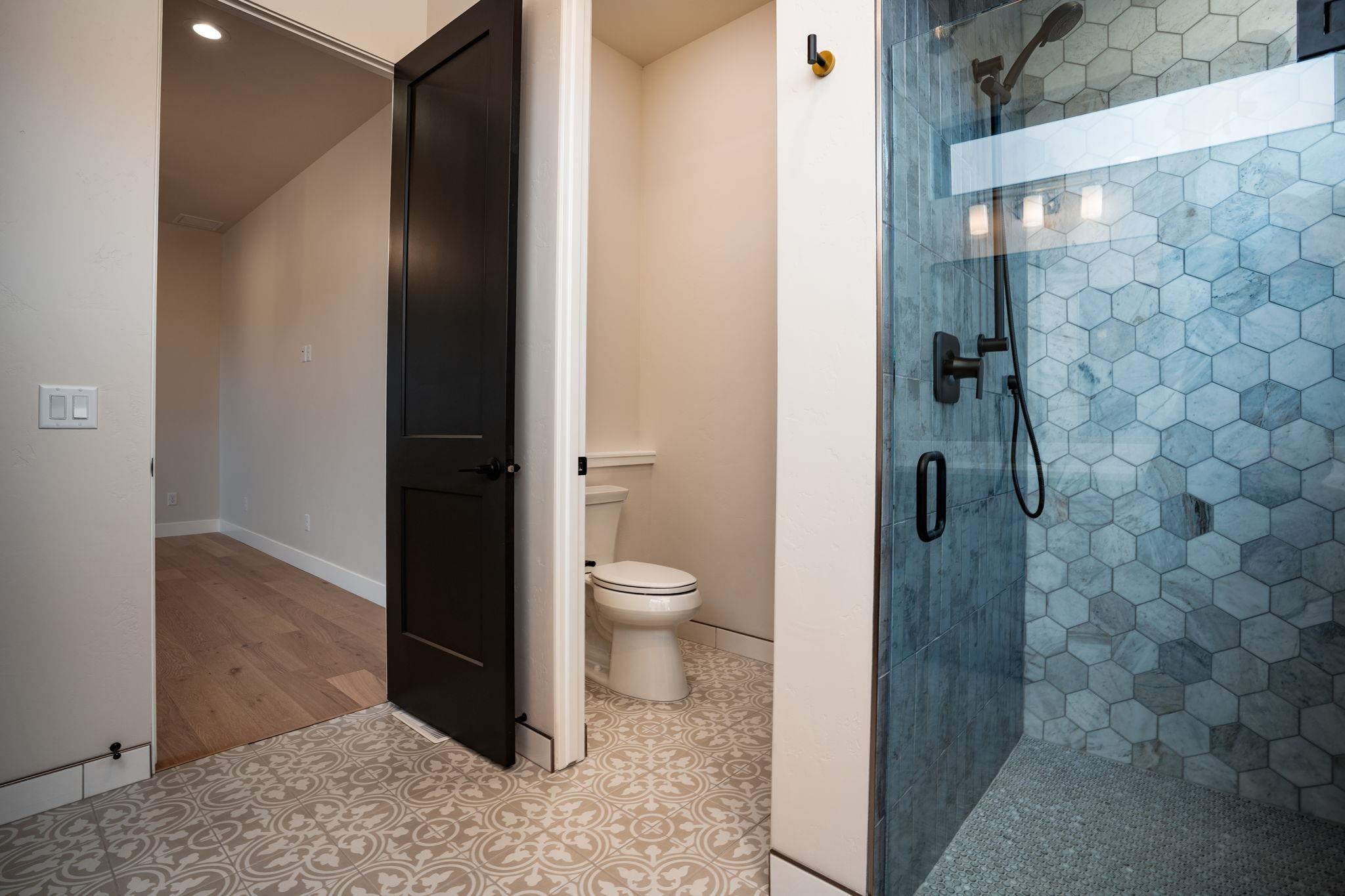 2304 Trail Ridge Road Grand Junction, CO 81507 - Photo 19 of 33 a bathroom with a granite countertop toilet and a shower