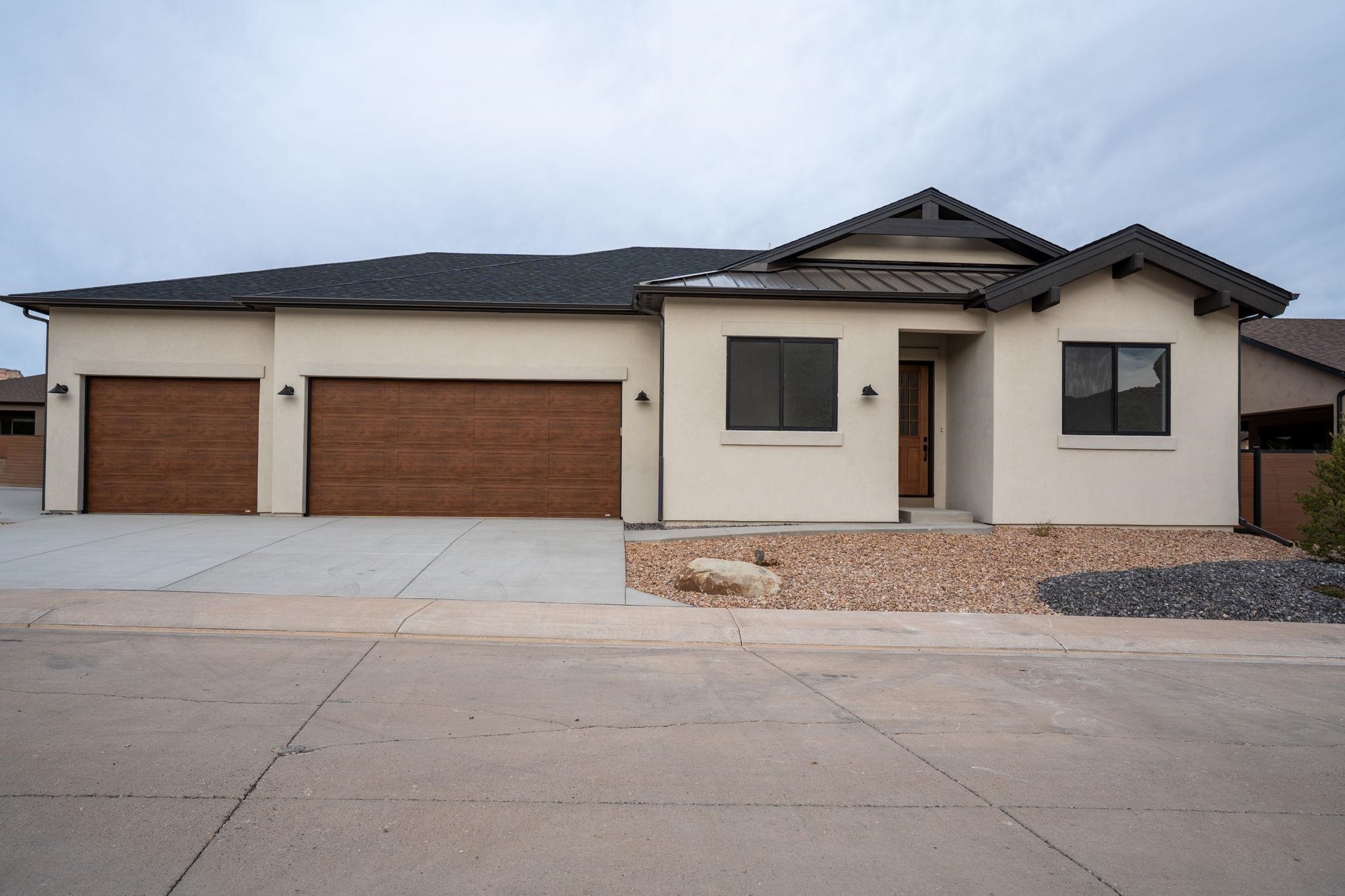 2304 Trail Ridge Road Grand Junction, CO 81507 - Photo 2 of 33 a front view of a house with a yard and garage