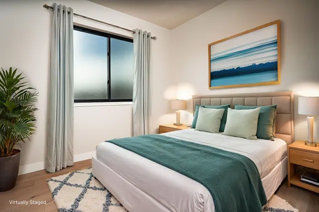 a bedroom with a bed and a potted plant