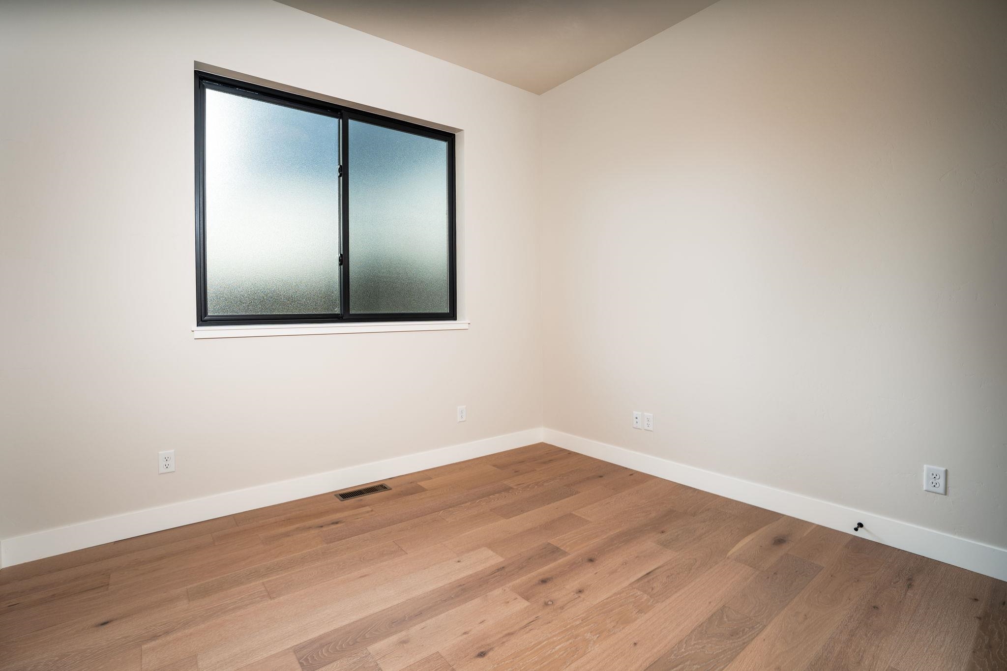 2304 Trail Ridge Road Grand Junction, CO 81507 - Photo 22 of 33 an empty room with wooden floor and mirror