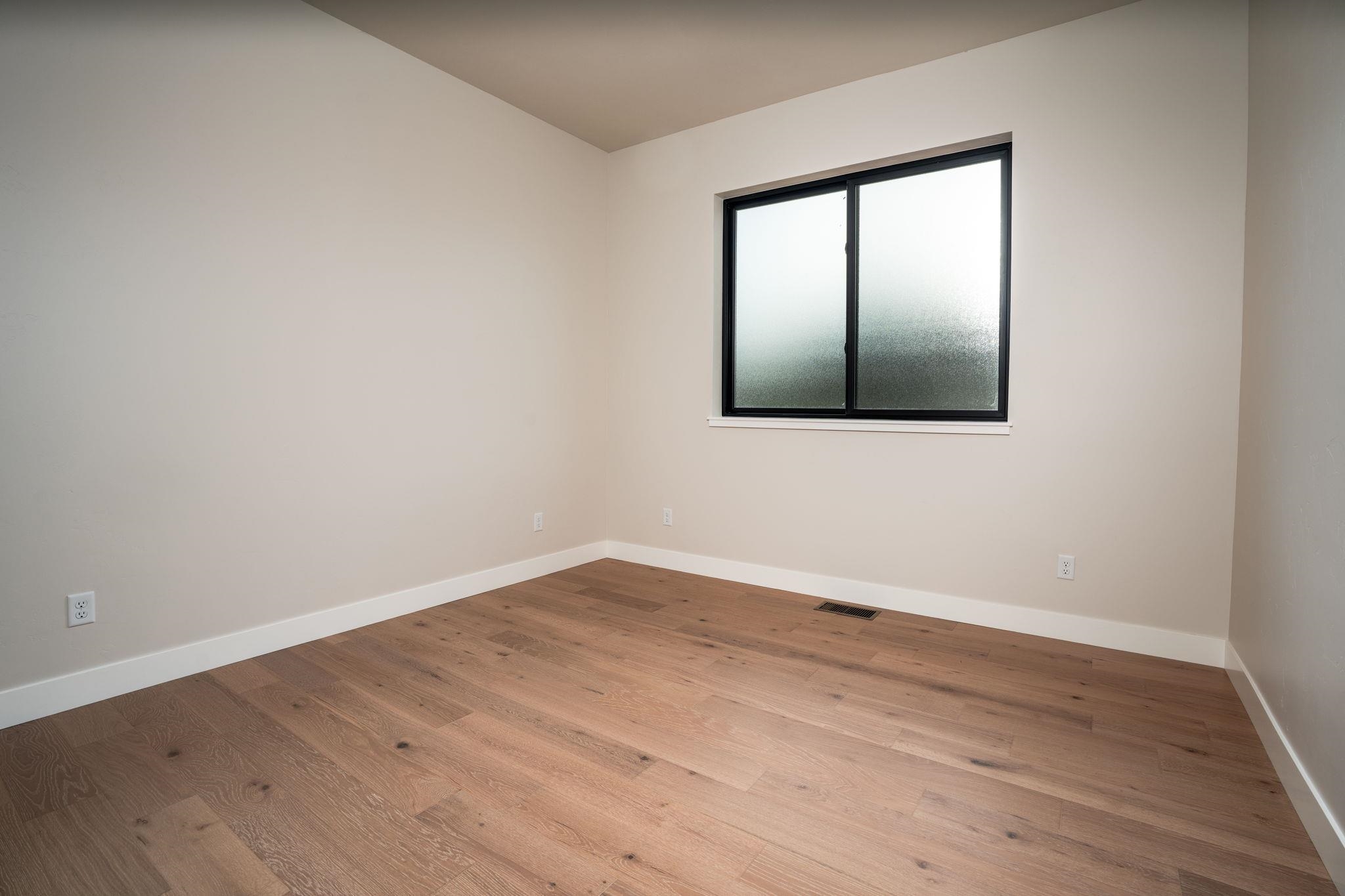 2304 Trail Ridge Road Grand Junction, CO 81507 - Photo 26 of 33 an empty room with wooden floor and windows