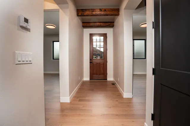 a view of a hallway with wooden floor
