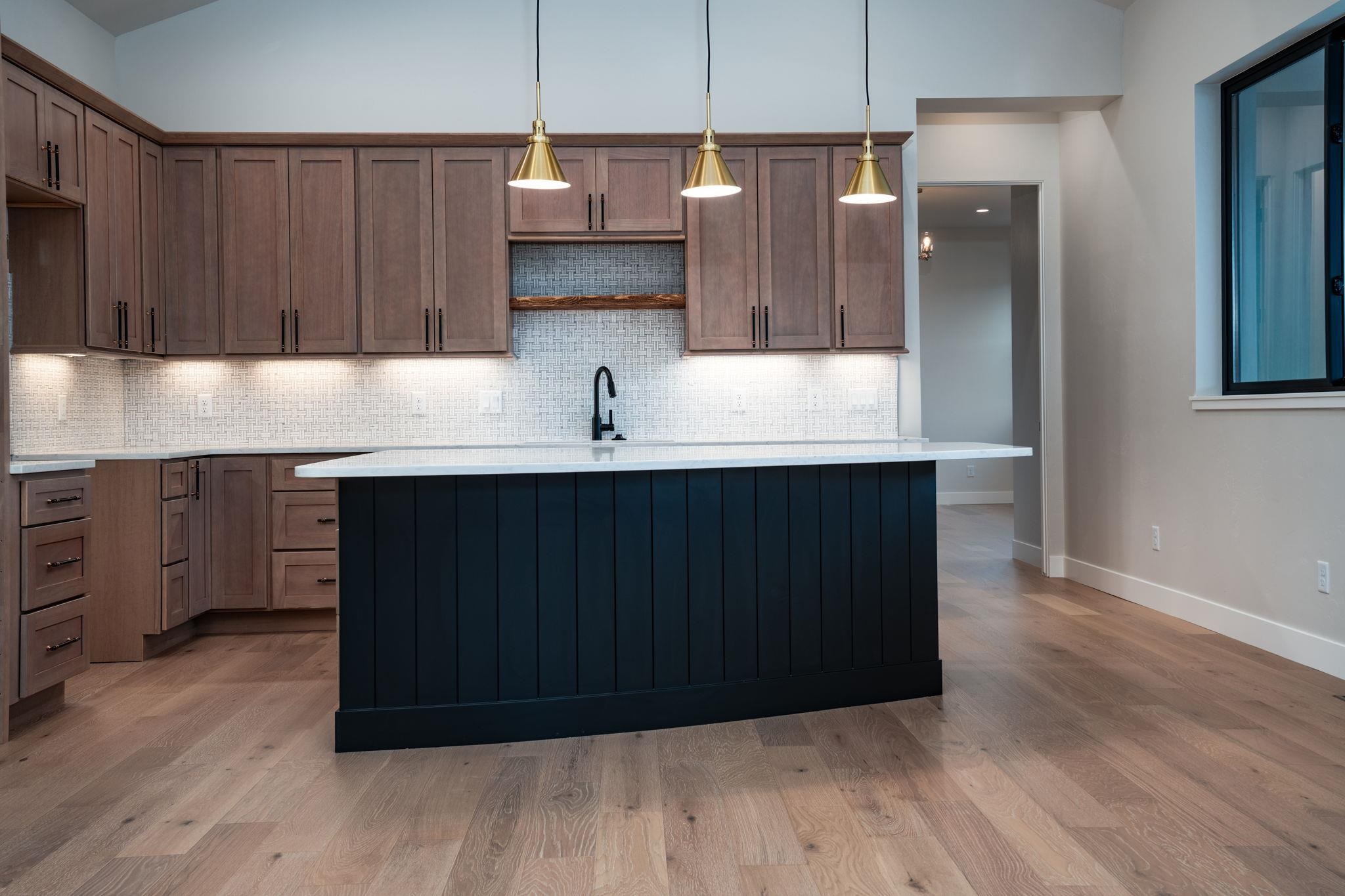 2304 Trail Ridge Road Grand Junction, CO 81507 - Photo 8 of 33 a kitchen with stainless steel appliances granite countertop a sink a microwave a refrigerator and wooden cabinets