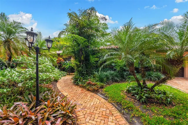 a view of a garden with plants and a fountain