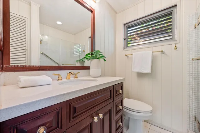 a very nice looking room with a large window and a potted plant