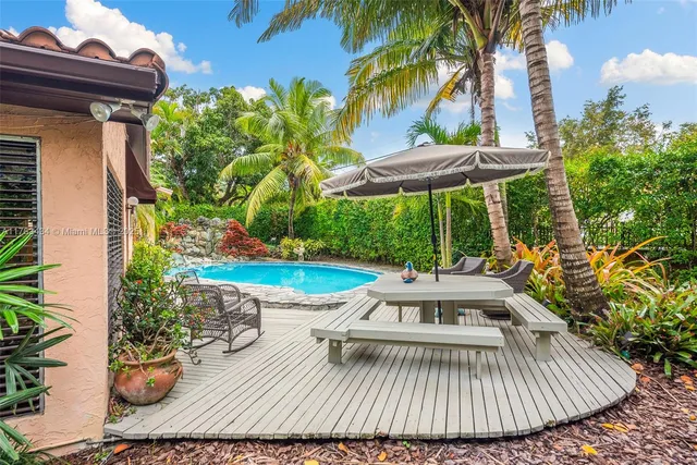 a view of a house with a yard and potted plants