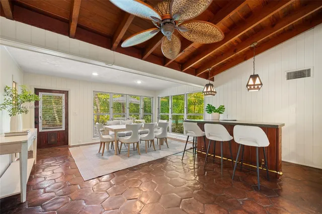 a view of a dining room with furniture window and outside view