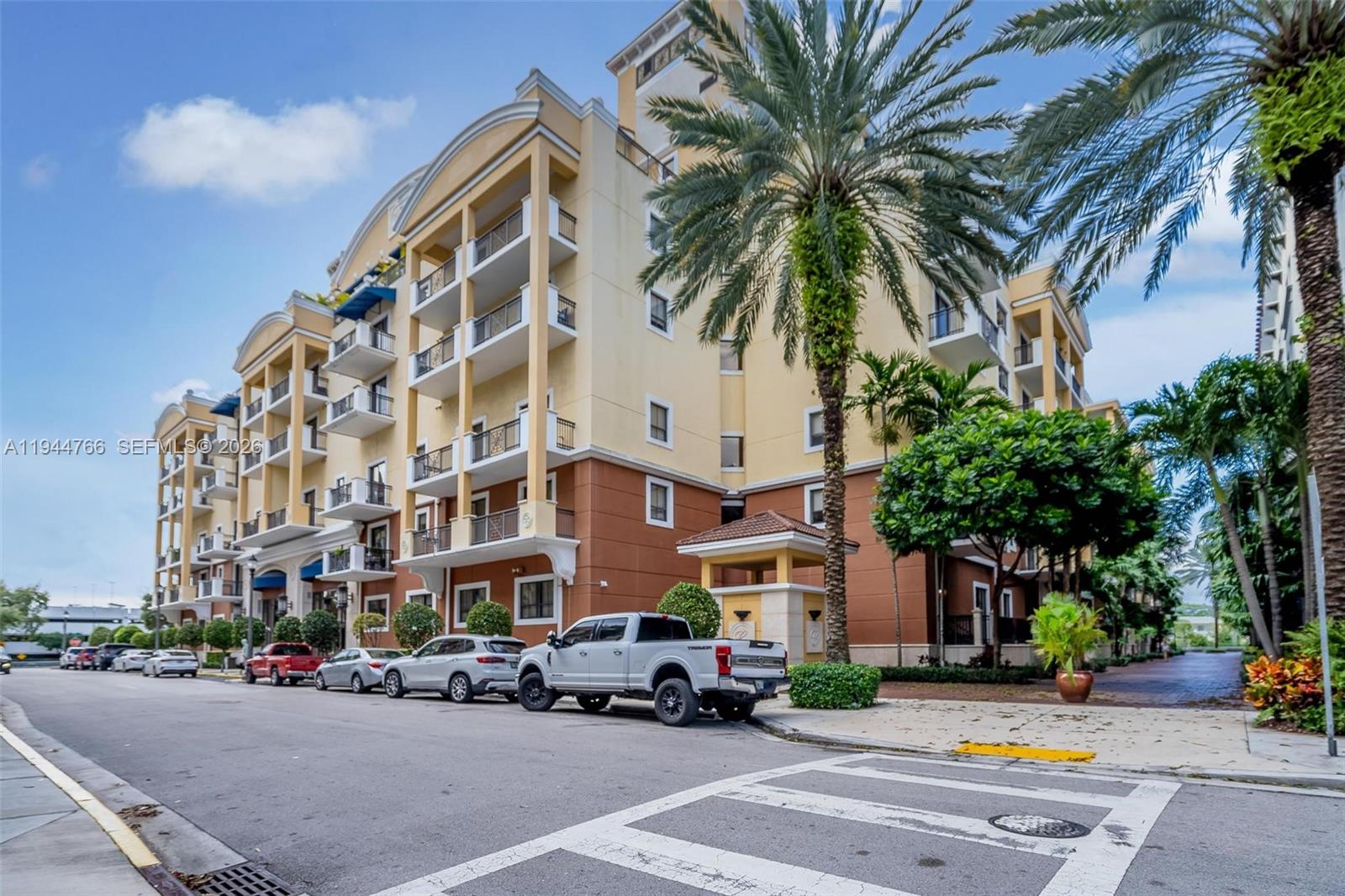 a building with street view and tall trees