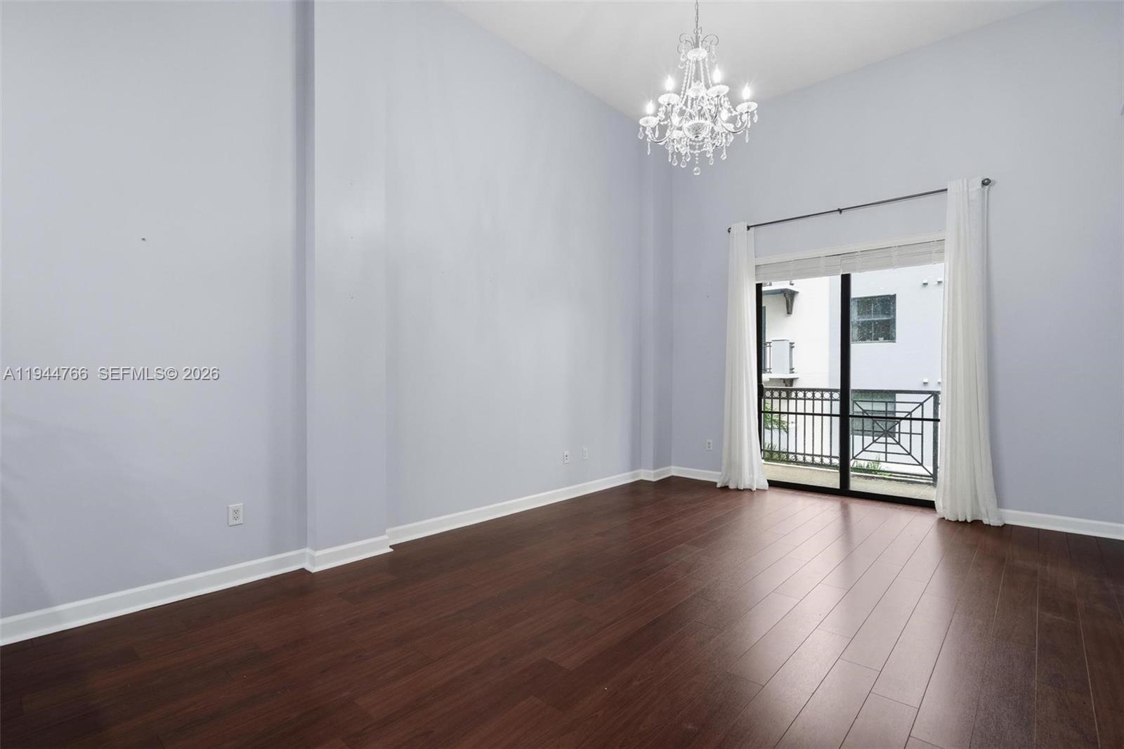 8395 Southwest 73rd Avenue, Unit 314 Miami, FL 33143 - Photo 11 of 49 a view of an empty room with wooden floor and a window