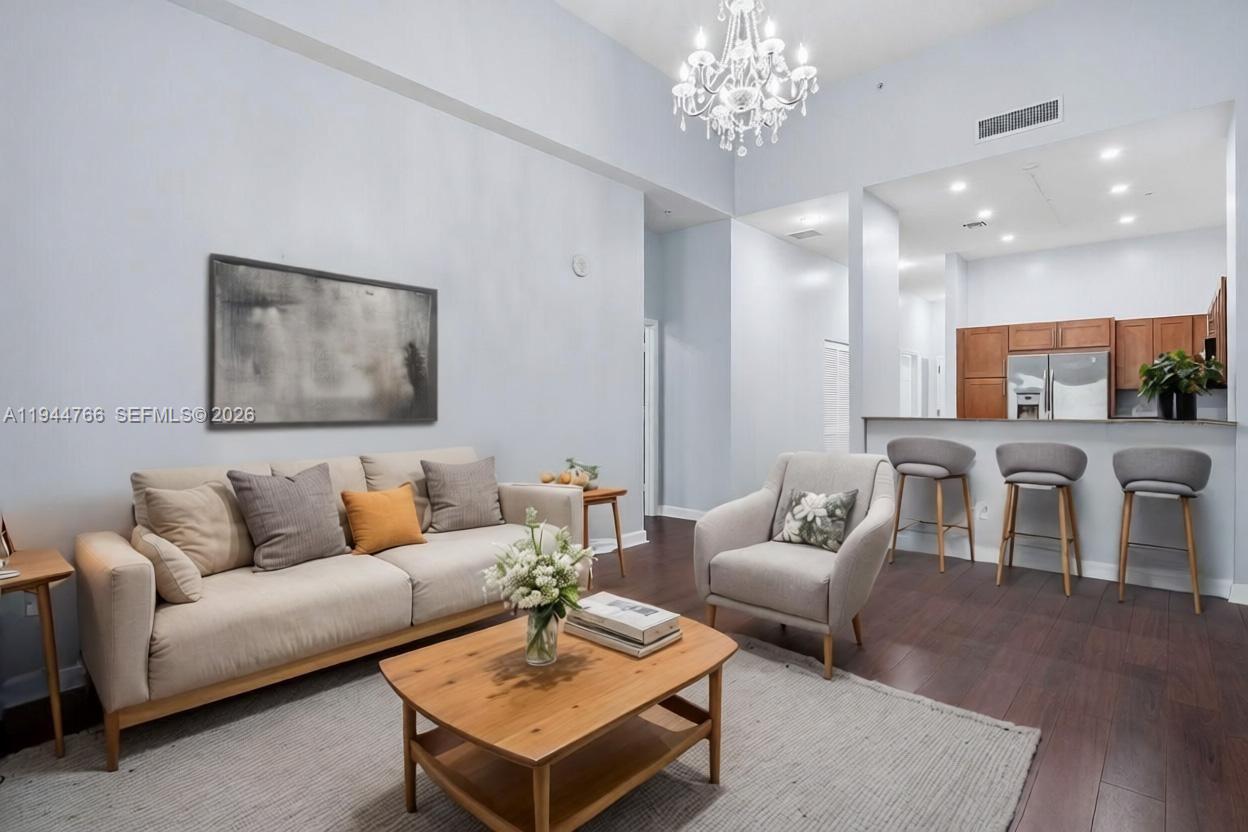8395 Southwest 73rd Avenue, Unit 314 Miami, FL 33143 - Photo 14 of 49 a living room with furniture and a chandelier