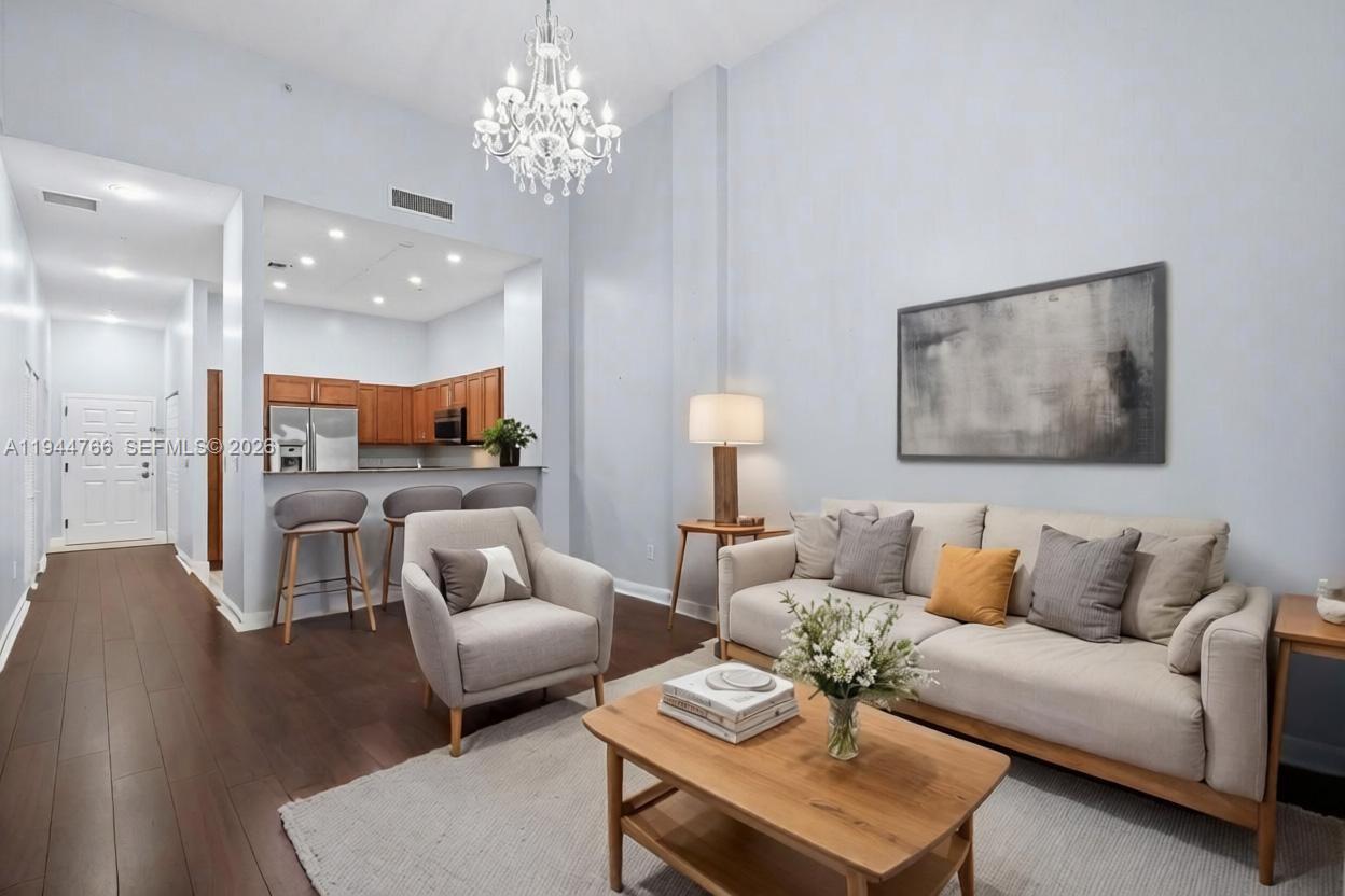8395 Southwest 73rd Avenue, Unit 314 Miami, FL 33143 - Photo 16 of 49 a living room with furniture and a chandelier