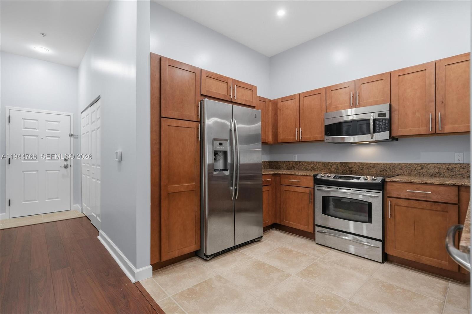 8395 Southwest 73rd Avenue, Unit 314 Miami, FL 33143 - Photo 18 of 49 a kitchen with stainless steel appliances granite countertop a refrigerator and a stove top oven