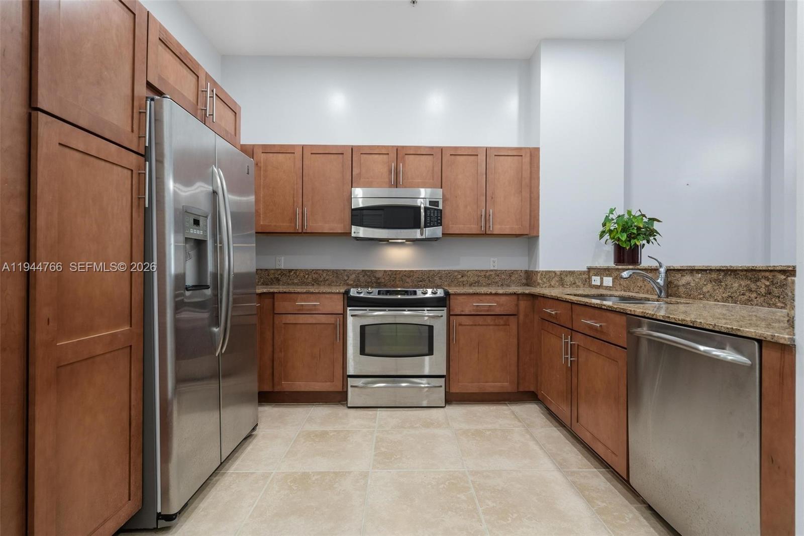 8395 Southwest 73rd Avenue, Unit 314 Miami, FL 33143 - Photo 20 of 49 a kitchen with a sink and a refrigerator