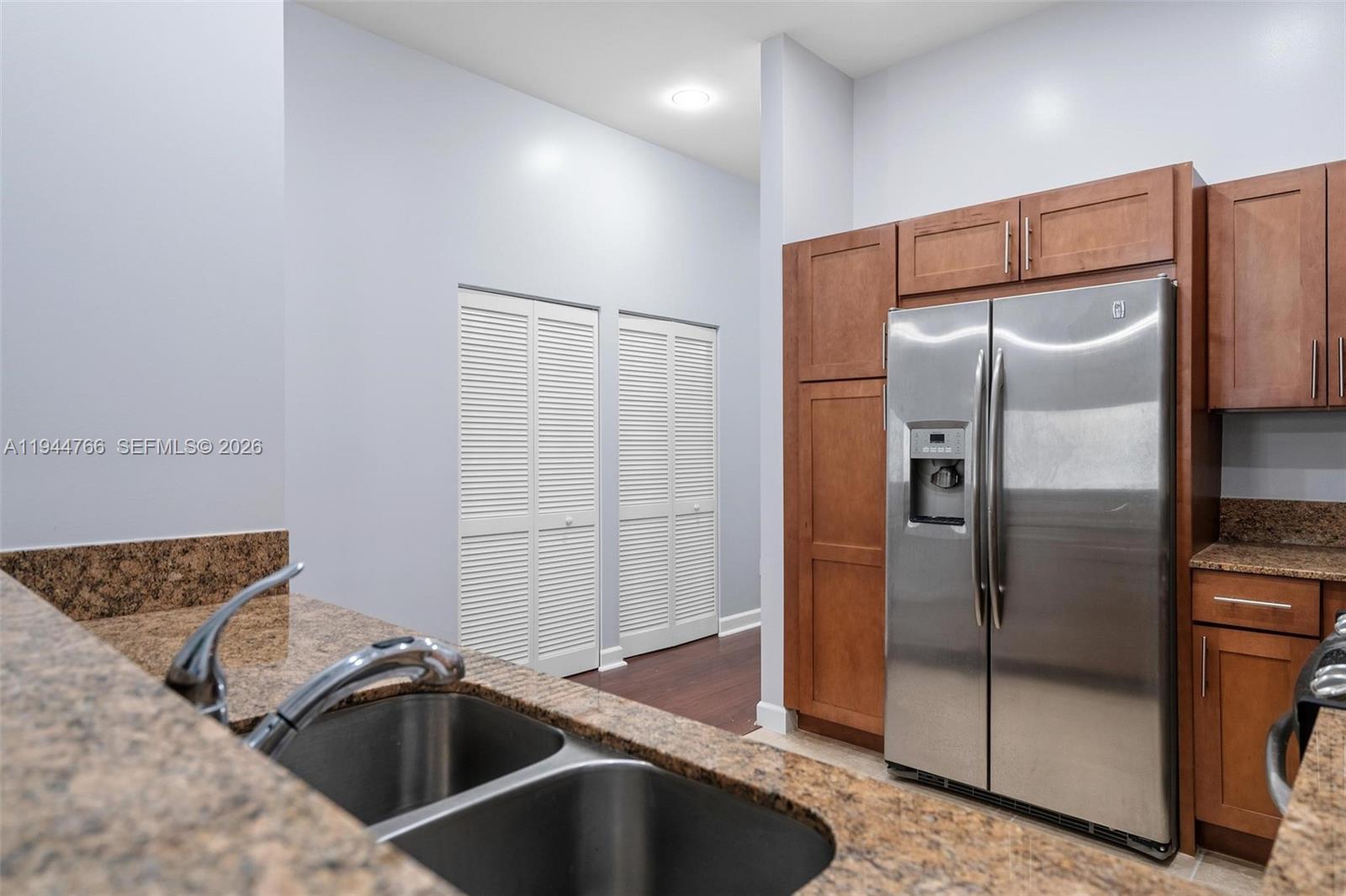 8395 Southwest 73rd Avenue, Unit 314 Miami, FL 33143 - Photo 23 of 49 a kitchen with stainless steel appliances granite countertop a refrigerator and a sink