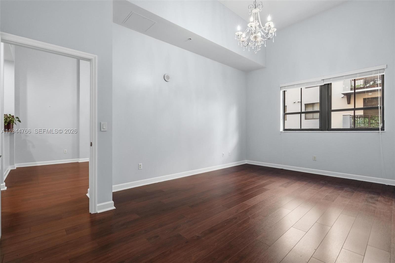 8395 Southwest 73rd Avenue, Unit 314 Miami, FL 33143 - Photo 33 of 49 a view of an empty room with wooden floor and a window