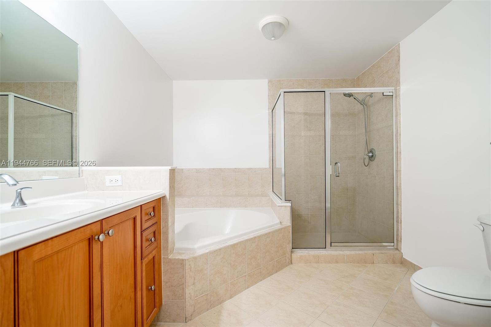 8395 Southwest 73rd Avenue, Unit 314 Miami, FL 33143 - Photo 38 of 49 a spacious bathroom with a granite countertop sink a toilet and shower