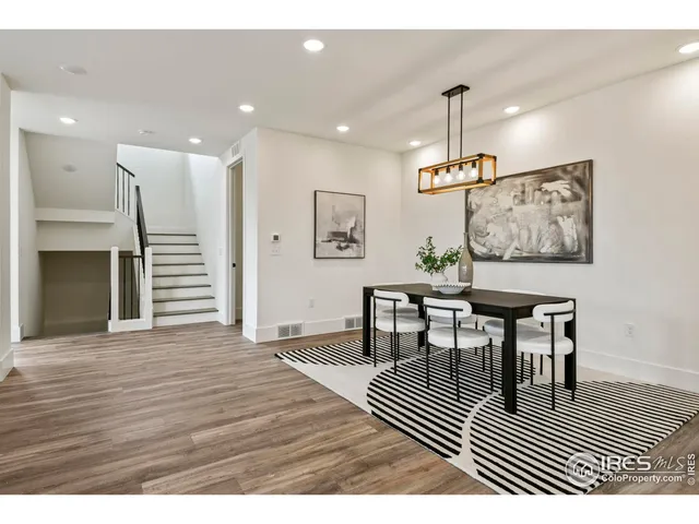 a view of a dining room with furniture wooden floor and chandelier