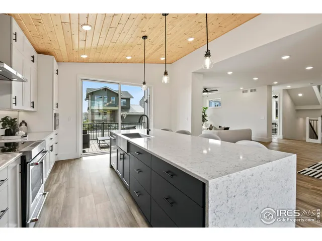 a kitchen with kitchen island a sink appliances and cabinets