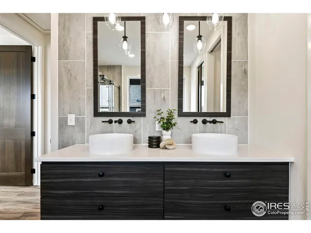 a bathroom with a bathtub shower sink vanity and a toilet