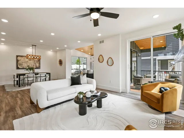 a living room with furniture potted plant and a ceiling fan