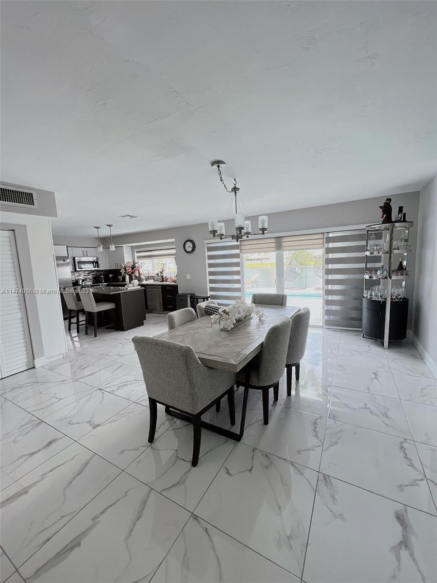 9357 Southwest 145th Place Miami, FL 33186 - Photo 2 of 15 a view of a dining room with furniture
