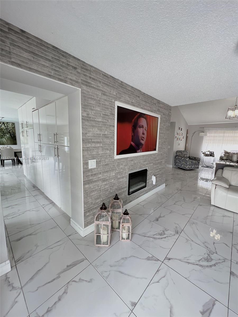 9357 Southwest 145th Place Miami, FL 33186 - Photo 5 of 15 a view of a livingroom with furniture and a flat screen tv