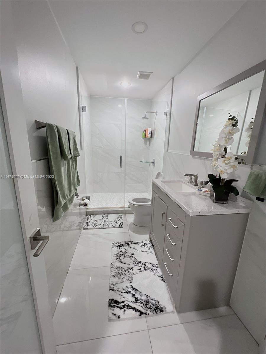 9357 Southwest 145th Place Miami, FL 33186 - Photo 9 of 15 a bathroom with a tub sink and mirror