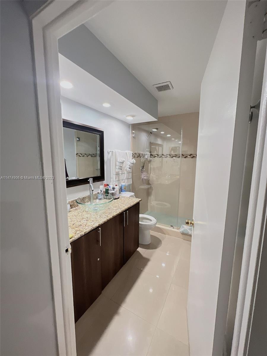 9357 Southwest 145th Place Miami, FL 33186 - Photo 10 of 15 a bathroom with a granite countertop sink mirror and a bathtub