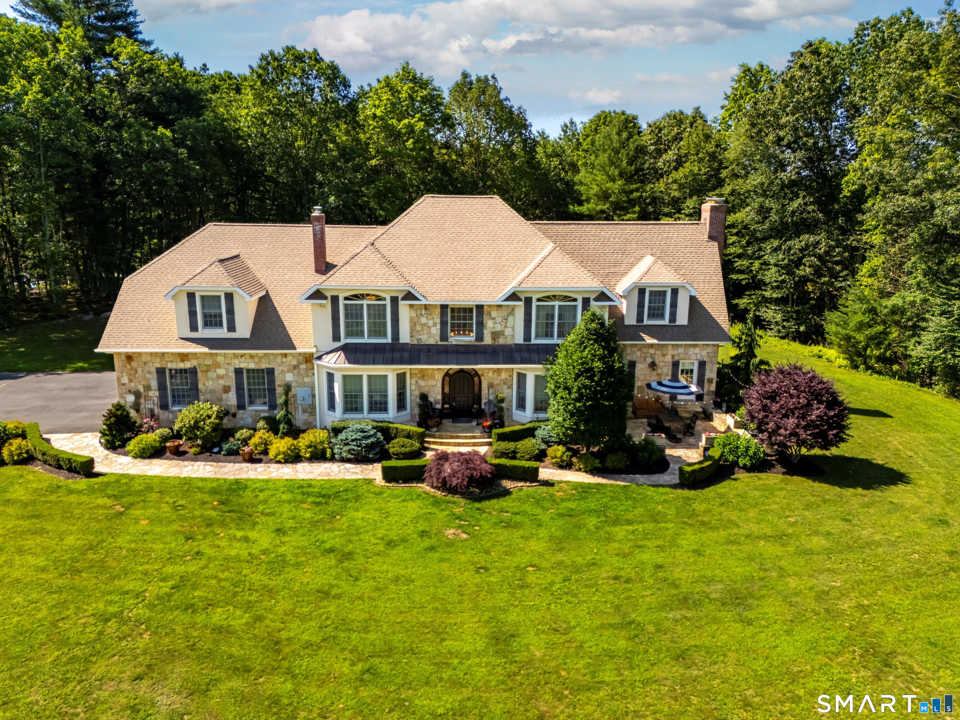 a front view of house with yard and green space