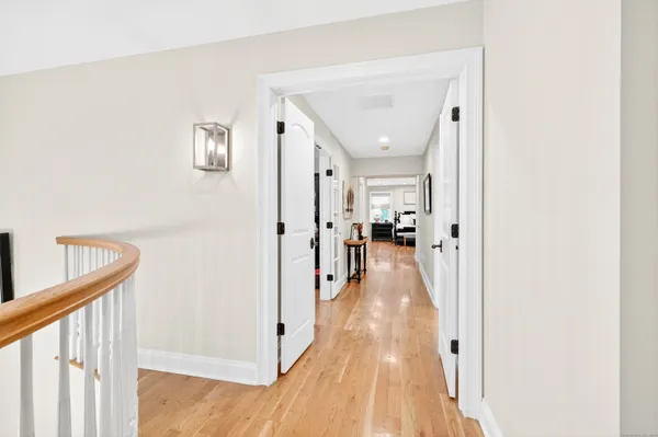 a view of a hallway with a wooden floor