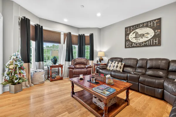 a living room with furniture a rug and a large window