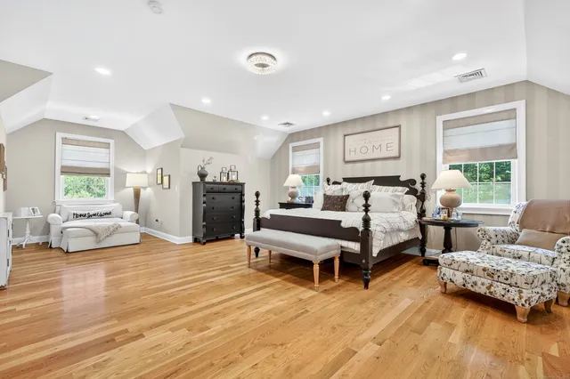 a bedroom with furniture and a wooden floor