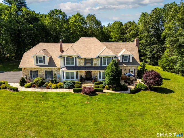 a front view of house with yard and green space