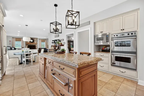 a kitchen with stainless steel appliances granite countertop a stove and cabinets