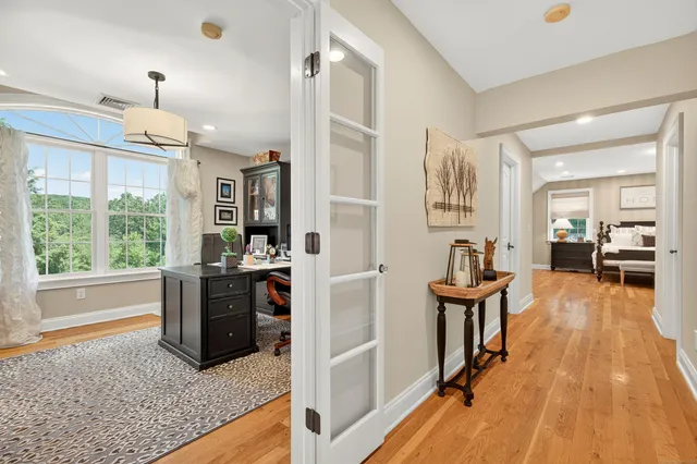 a view of a livingroom with furniture hardwood floor and a ceiling fan