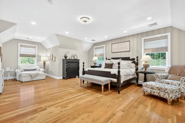 a bedroom with furniture and a wooden floor