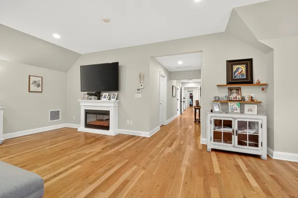 a view of a livingroom with furniture and a flat screen tv