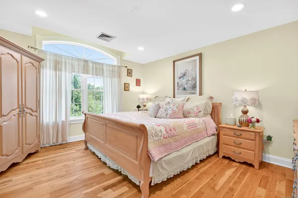 a large bedroom with a bed and large windows