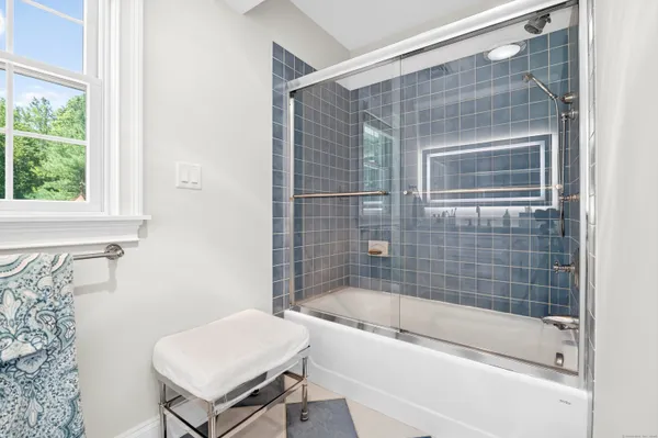 a bathroom with a bathtub and a shower