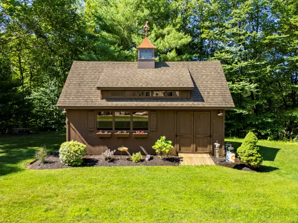a front view of a house with garden