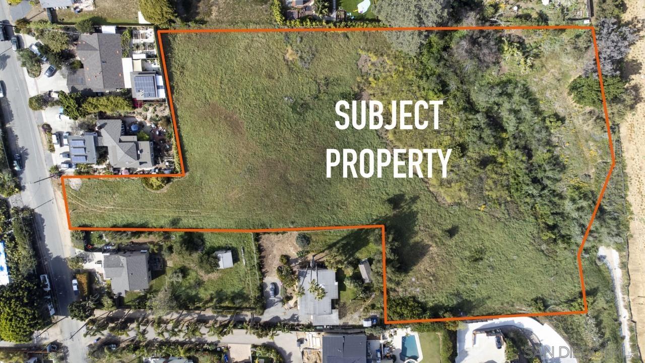 an aerial view of a residential apartment building with a yard and potted plants