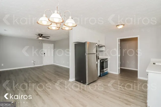 a view of a kitchen with a refrigerator and a chandelier