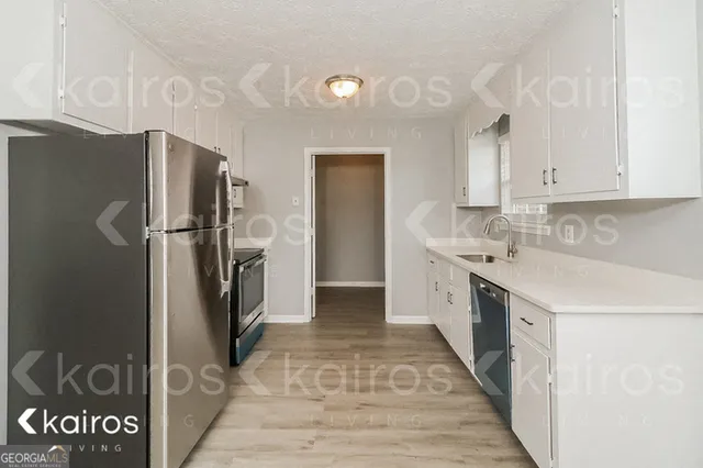 a kitchen with a refrigerator and a sink