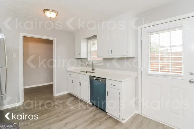 a view of cabinets a sink and dishwasher in a kitchen