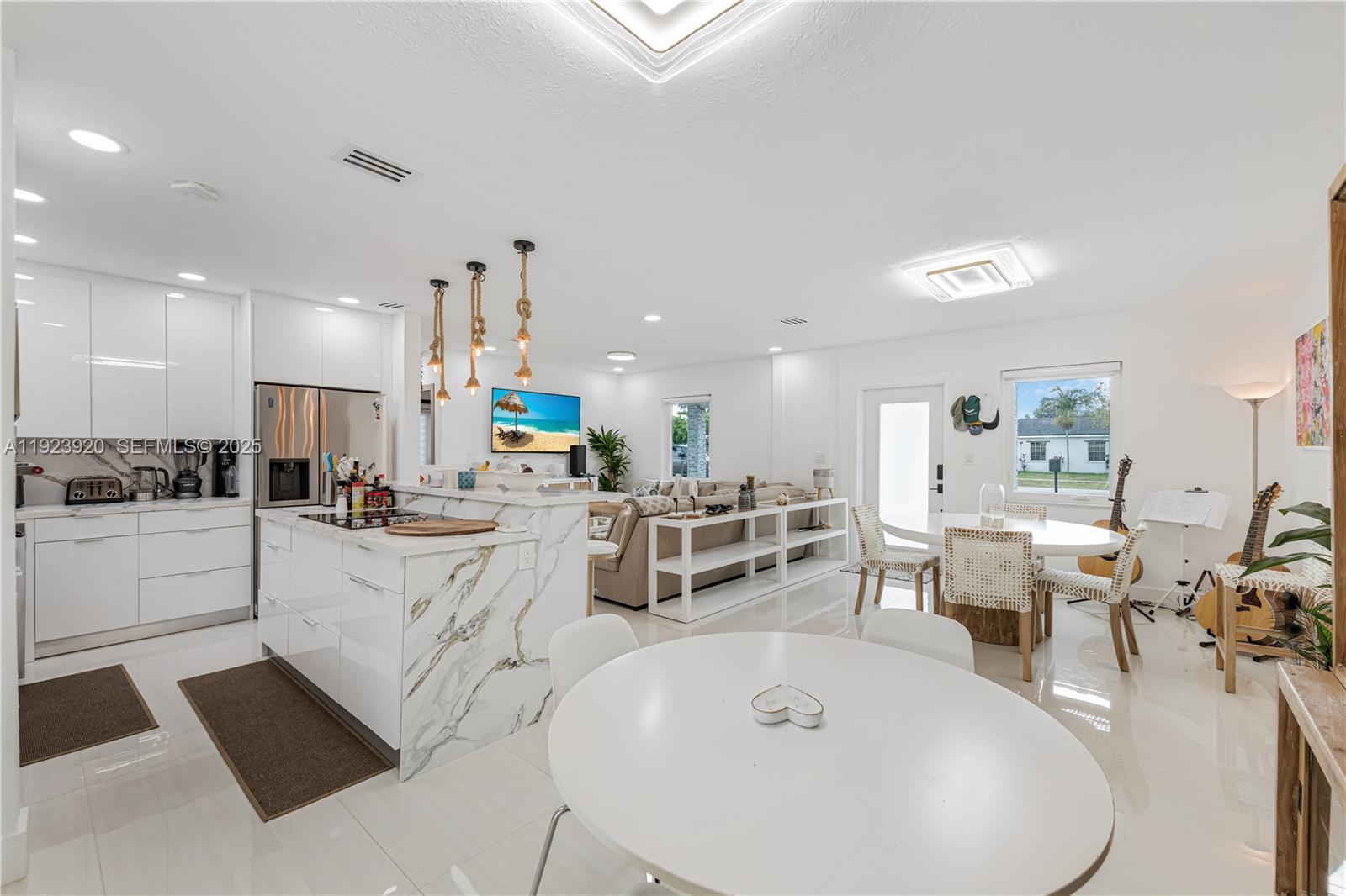 7235 Southwest 39th Street Miami, FL 33155 - Photo 11 of 30 a large white kitchen with lots of counter space and furniture