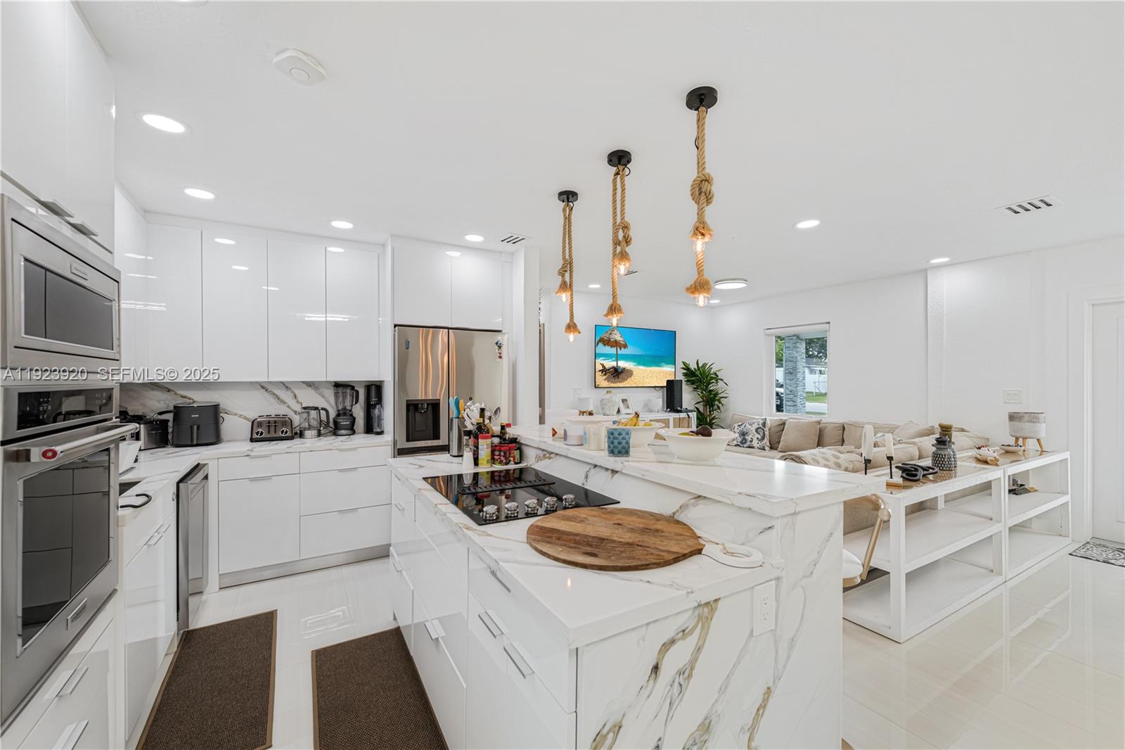 7235 Southwest 39th Street Miami, FL 33155 - Photo 12 of 30 a kitchen with a stove a sink and a refrigerator