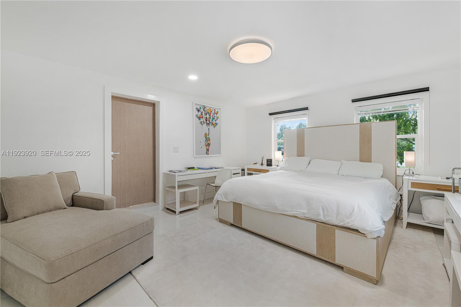 7235 Southwest 39th Street Miami, FL 33155 - Photo 16 of 30 a spacious bedroom with a bed and a couch