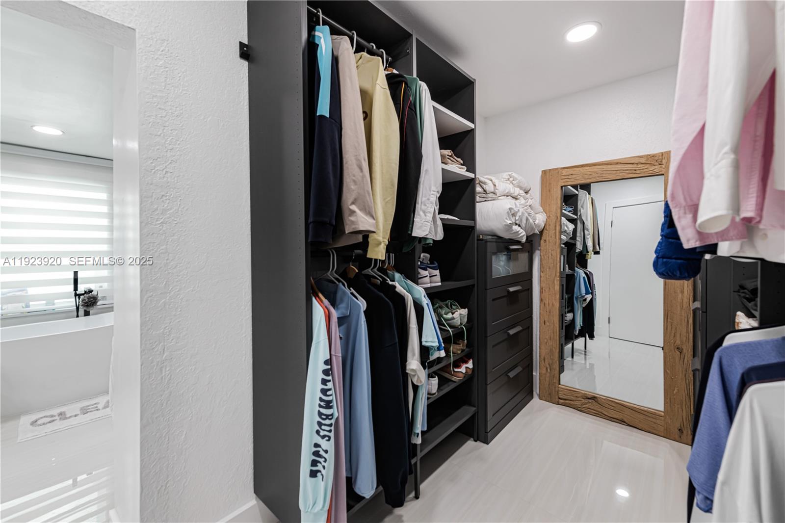 7235 Southwest 39th Street Miami, FL 33155 - Photo 17 of 30 a view of walk in closet with clothes and shoes