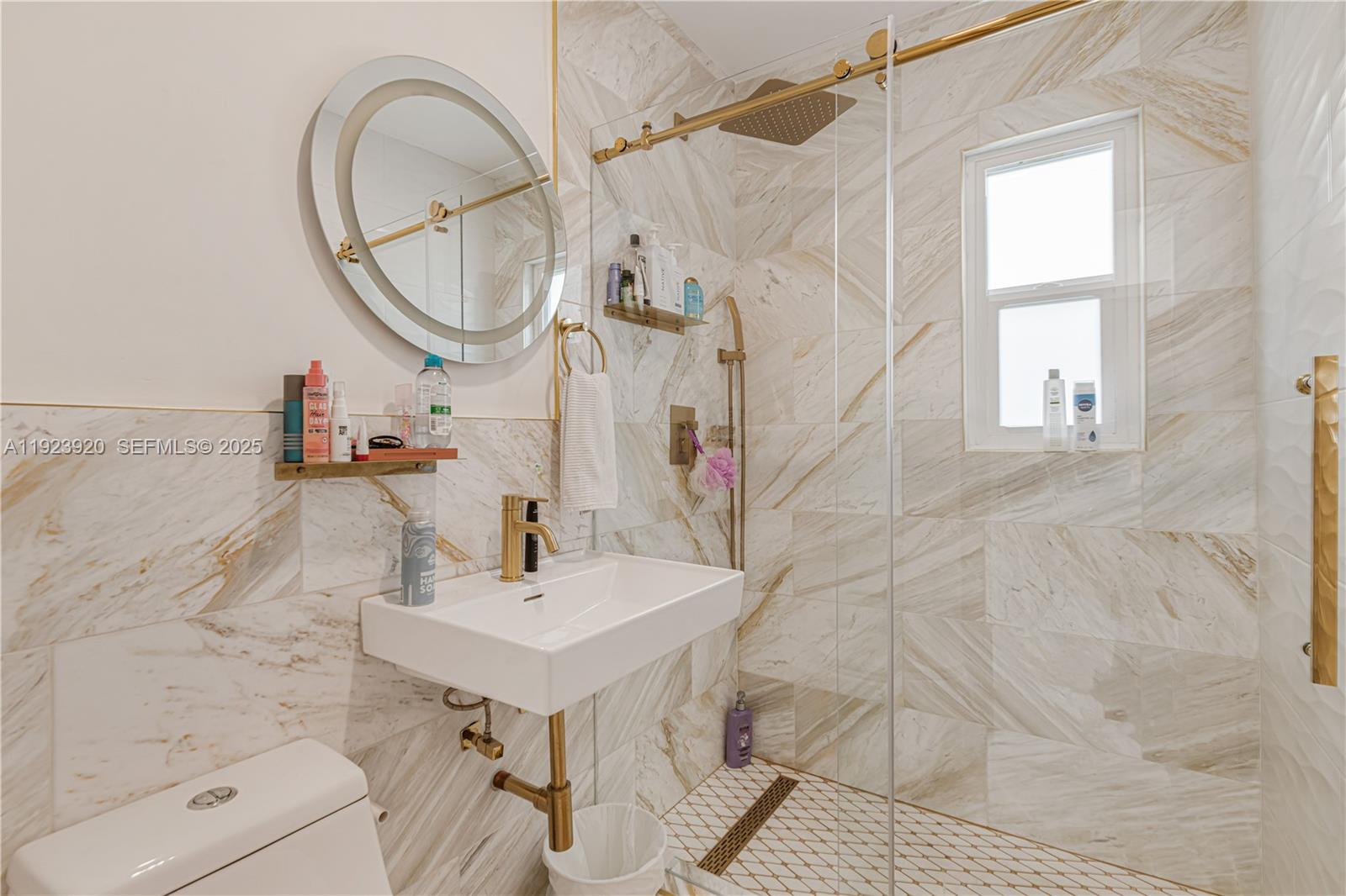 7235 Southwest 39th Street Miami, FL 33155 - Photo 23 of 30 a bathroom with a sink a mirror and a shower