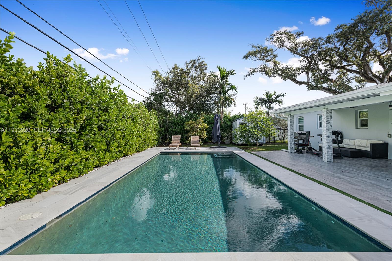 7235 Southwest 39th Street Miami, FL 33155 - Photo 24 of 30 a view of a swimming pool with a patio